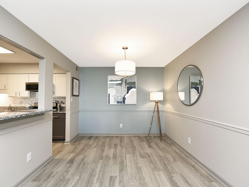 Dining area with hardwood-style flooring and overhead lighting