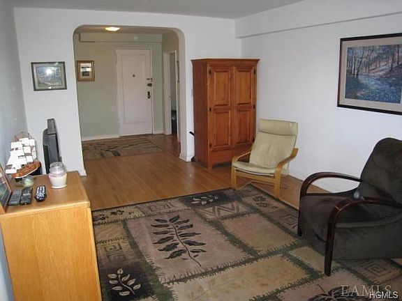 Sunny Living Room with refinished hardwood floors. Room size is 19'-2" x 12'-0"