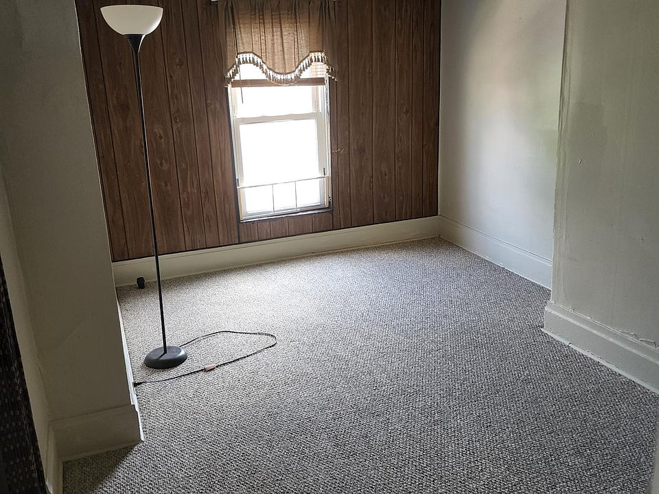 Living room with walk-in closet and new carpeting.