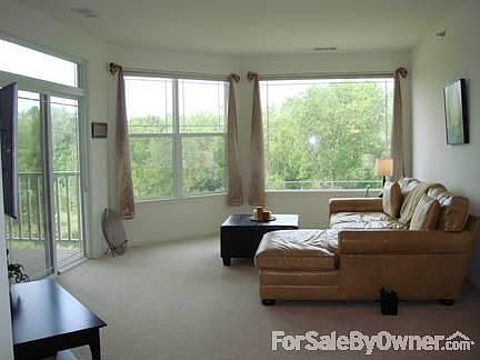 Spacious Living Room
						:
						Relax in the living room with great views of nature to your west!