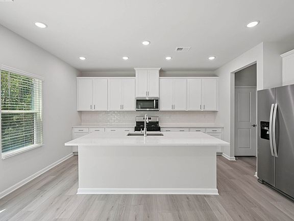 Kitchen in the Taylorsville floorplan at Cadence Meadows in Zebulon, NC.