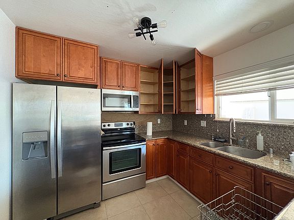 Kitchen w all Whirlpool appliance - side-by-side refrigerator, microwave, stove and dishwasher. Newly changed faucet in kitchen and new garbage disposal.