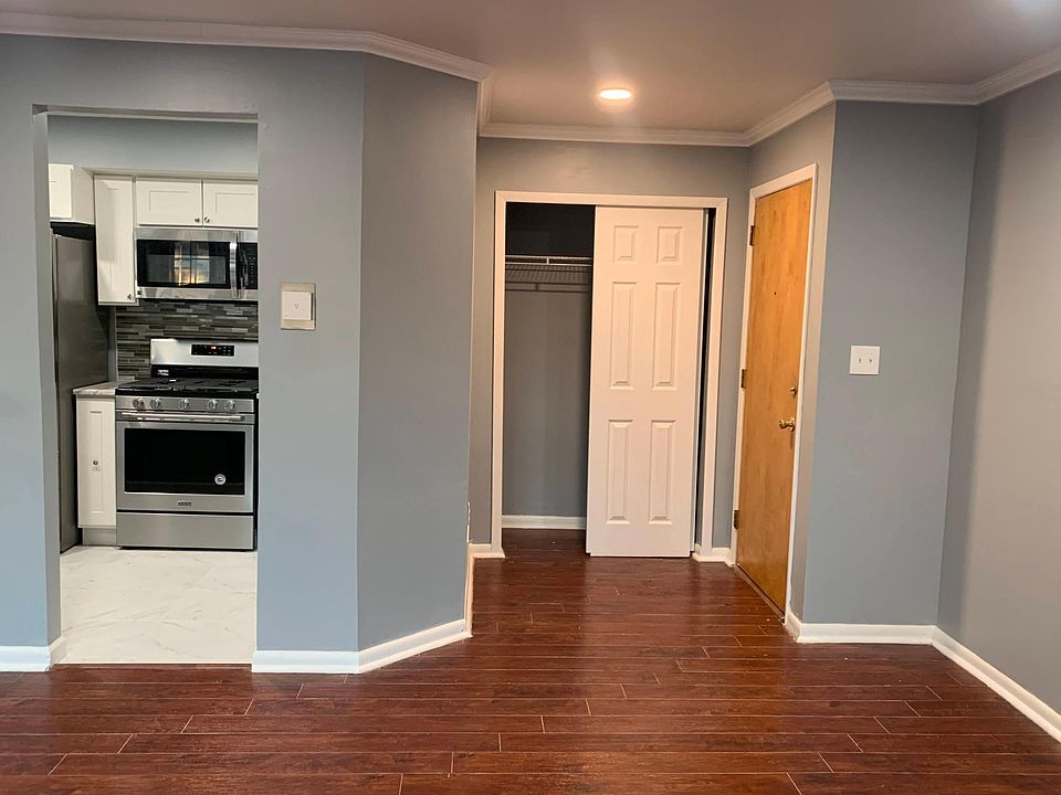 Living area looking towards kitchen and entryway.