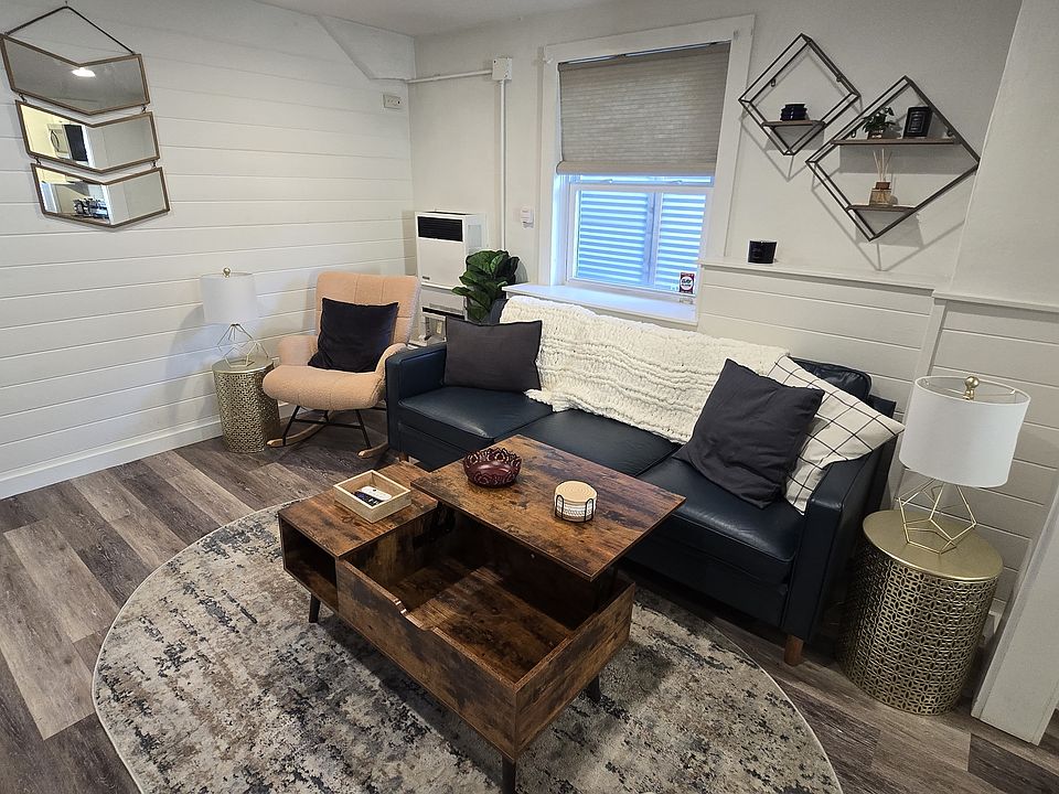 Cozy living room with a lift-top coffee table that doubles as a hidden workspace for laptops or dining.