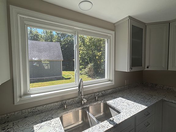 Beautiful large window in kitchen overlooking back yard and barn. .85 Acres