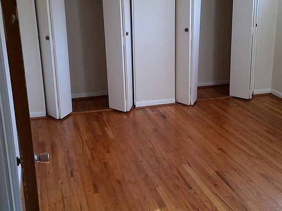 Master bedroom with ceiling fan and large, double closets.