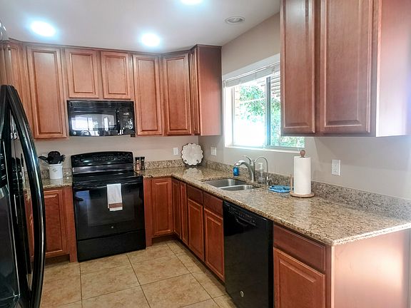 Beautiful kitchen with ceiling height cupboards and granite counter tops