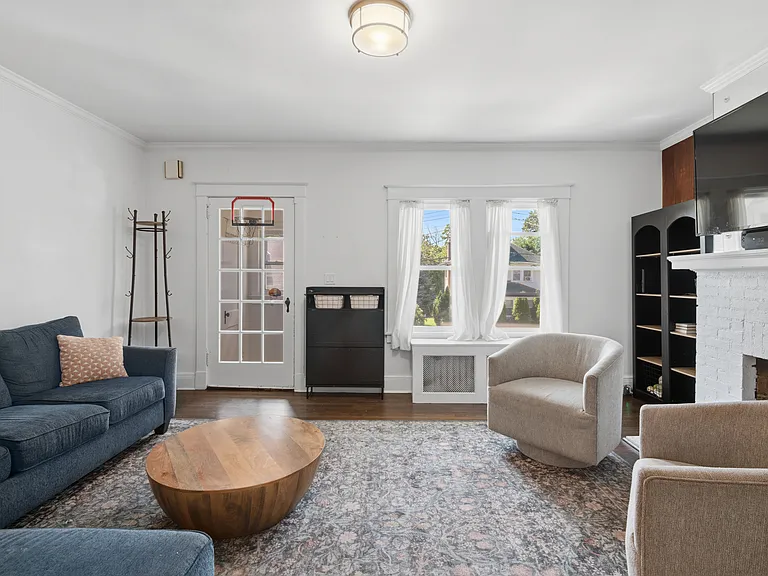Living room with fireplace and hardwood flooring