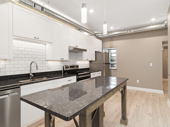 Notice the glass pendant lights and exposed spiral ductwork also new laminate flooring!