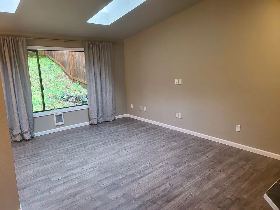Living room with skylights and vaulted ceilings