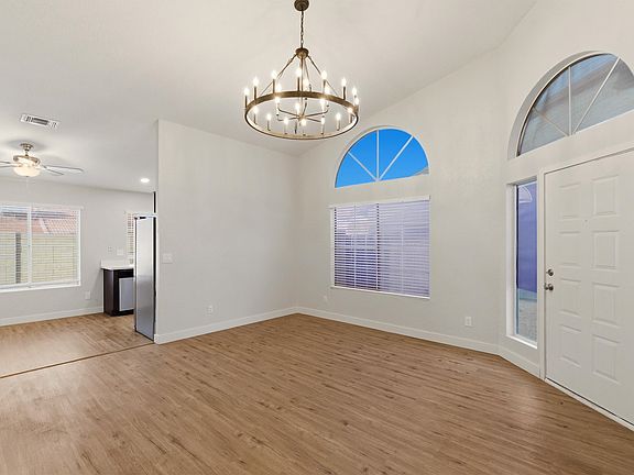 LVP flooring in all high traffic areas. Wagon wheel chandelier with vaulted living room ceilings. Lots of natural light in main living spaces