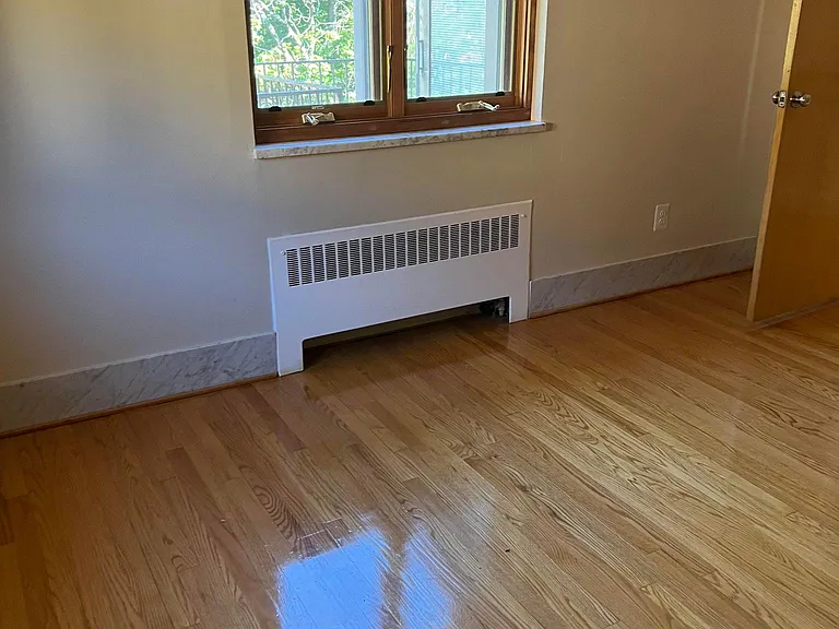 bedroom with hardwood floors finished 1.5 years ago