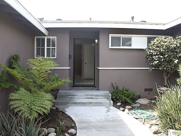 Entry.  New concrete walkway and well manicured grouds