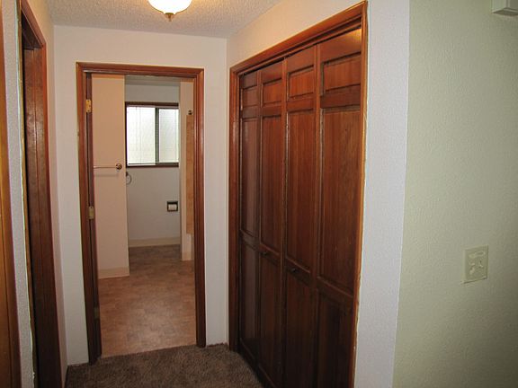 Hallway with in-unit laundry and bathroom entrance