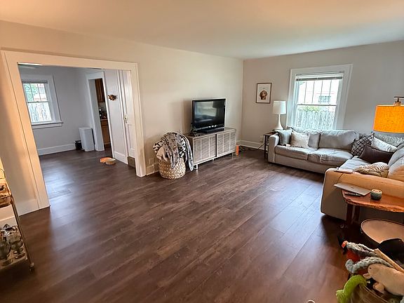Large dinning room. Access to the kitchen and doorway leading to the upstairs suite. Luxury vinyl is being installed!
