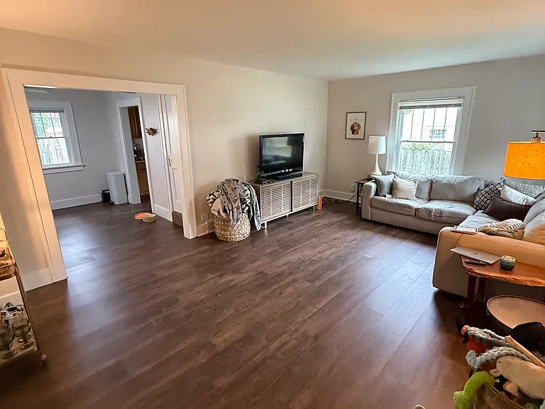 Large dinning room. Access to the kitchen and doorway leading to the upstairs suite. Luxury vinyl is being installed!