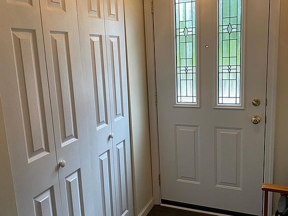 large entry way closet with custom front door