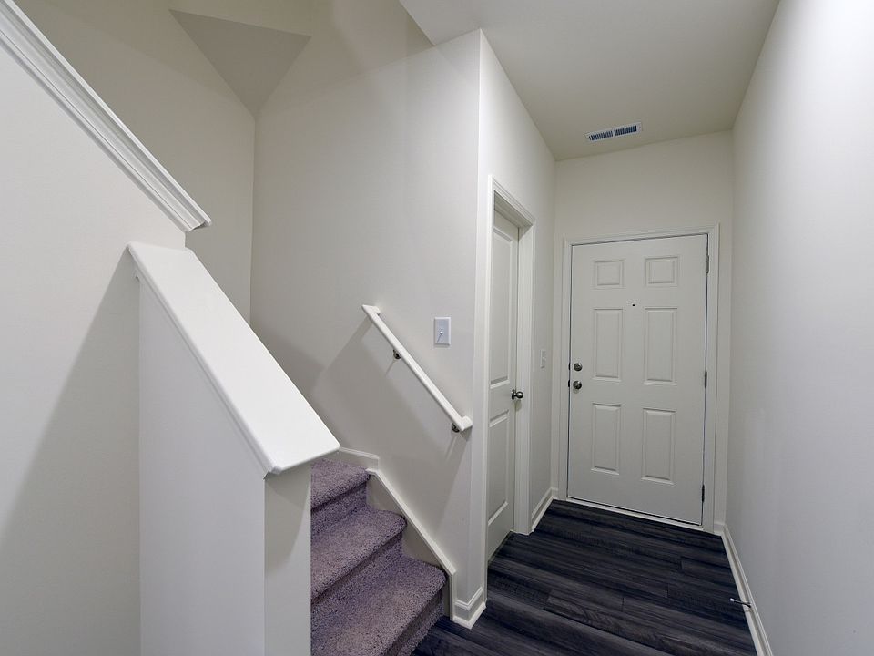 Main entrance, and half bath access as you enter. Bottom entry of staircase.