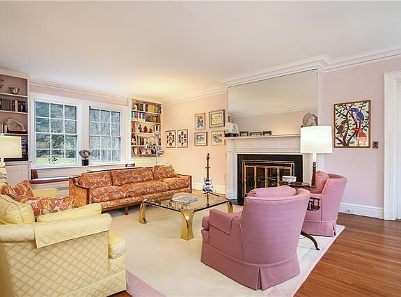 Off to the right is the spacious living room with built-in bookshelves and large windows which offer a view of the backyard.