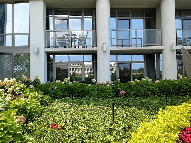 View of unit from patio (unit with chairs and table on balcony)