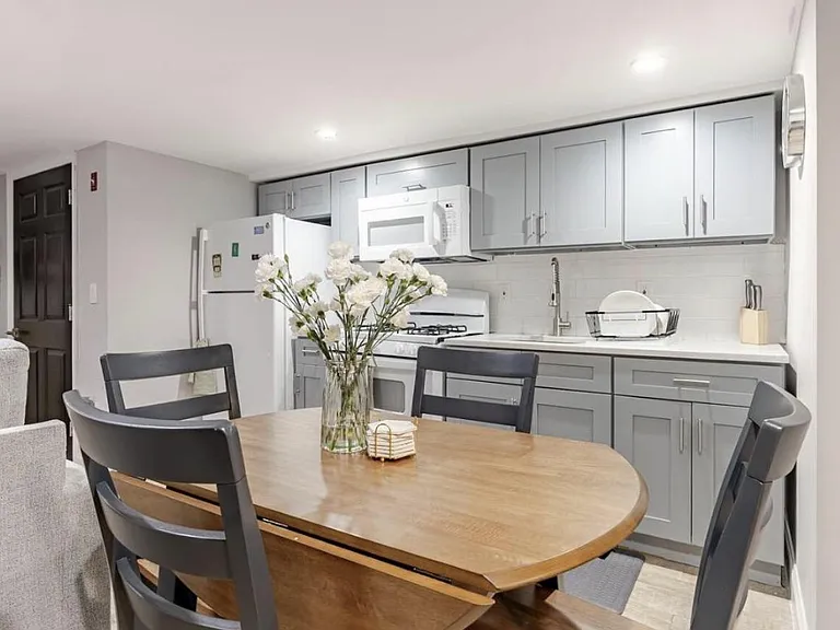 Eat-in kitchen features gray shaker cabinetry, ample counter space, and a full appliance package for easy everyday cooking.