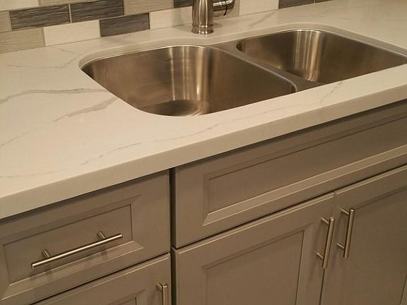 Large deep stainless steel sinks with custom one handle sprayer.