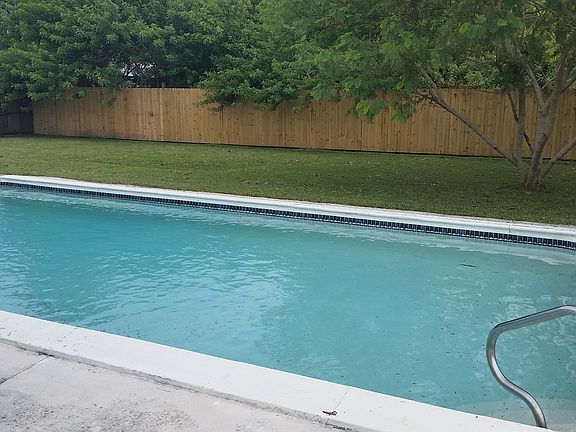 pool with fenced back yard