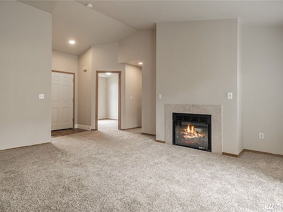 The foyer opens into a lumious vaulted living room. 