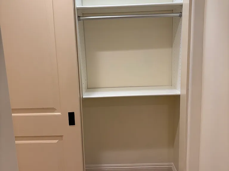 Large closet with California Closet built-ins for lots of storage