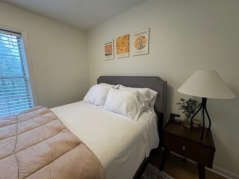 Full sized bed with 43 inch smart TV in room (not shown)