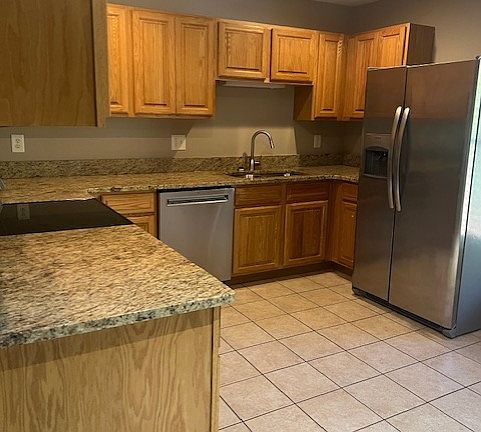 Kitchen feautres granite counters and stainless steel appliances