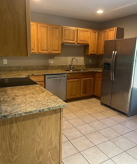 Kitchen feautres granite counters and stainless steel appliances