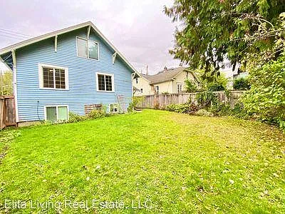 Older photo (house has fresh, new gray paint - see photo of front door). Large garden with lawn - partial sun.