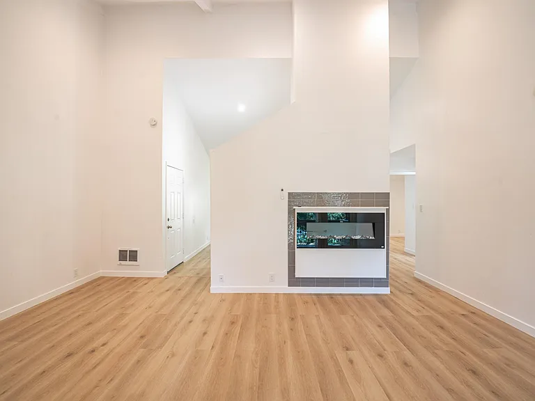 Another view of large living room showing the new electric fireplace with remote control.
You can get a sense of the how large this living room is where one could create two spaces in one: a home office on one side and a true living good sized living ro