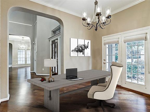 This room could easily be a formal living room with new chandelier lighting and bright stationary doors.