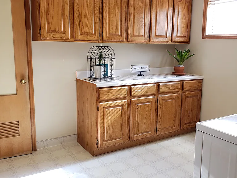 Large laundry room with plenty of storage.