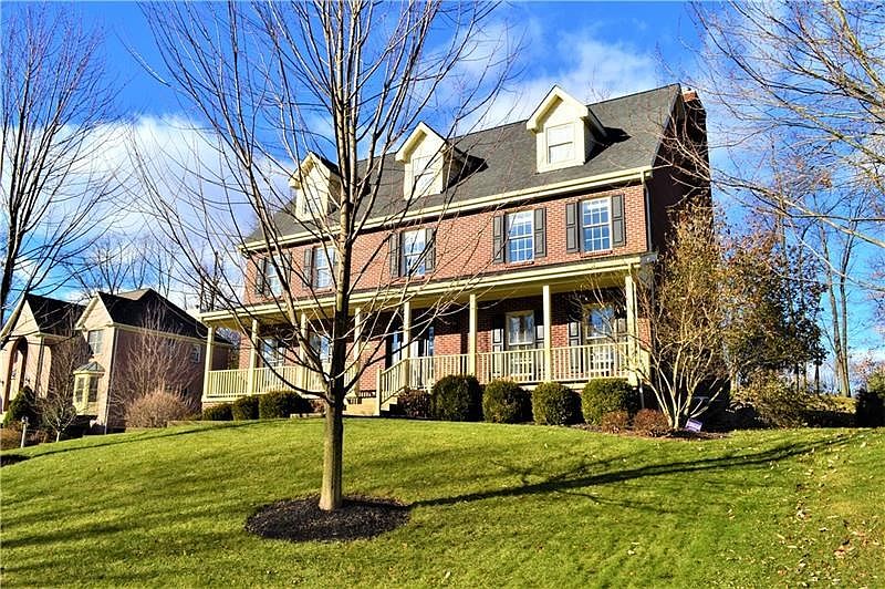 Beautiful Brick Home with covered front porch spanning the entire home.