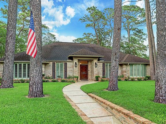 This stunning home on a generous size lot is surrounded by lush landscaping and mature trees.