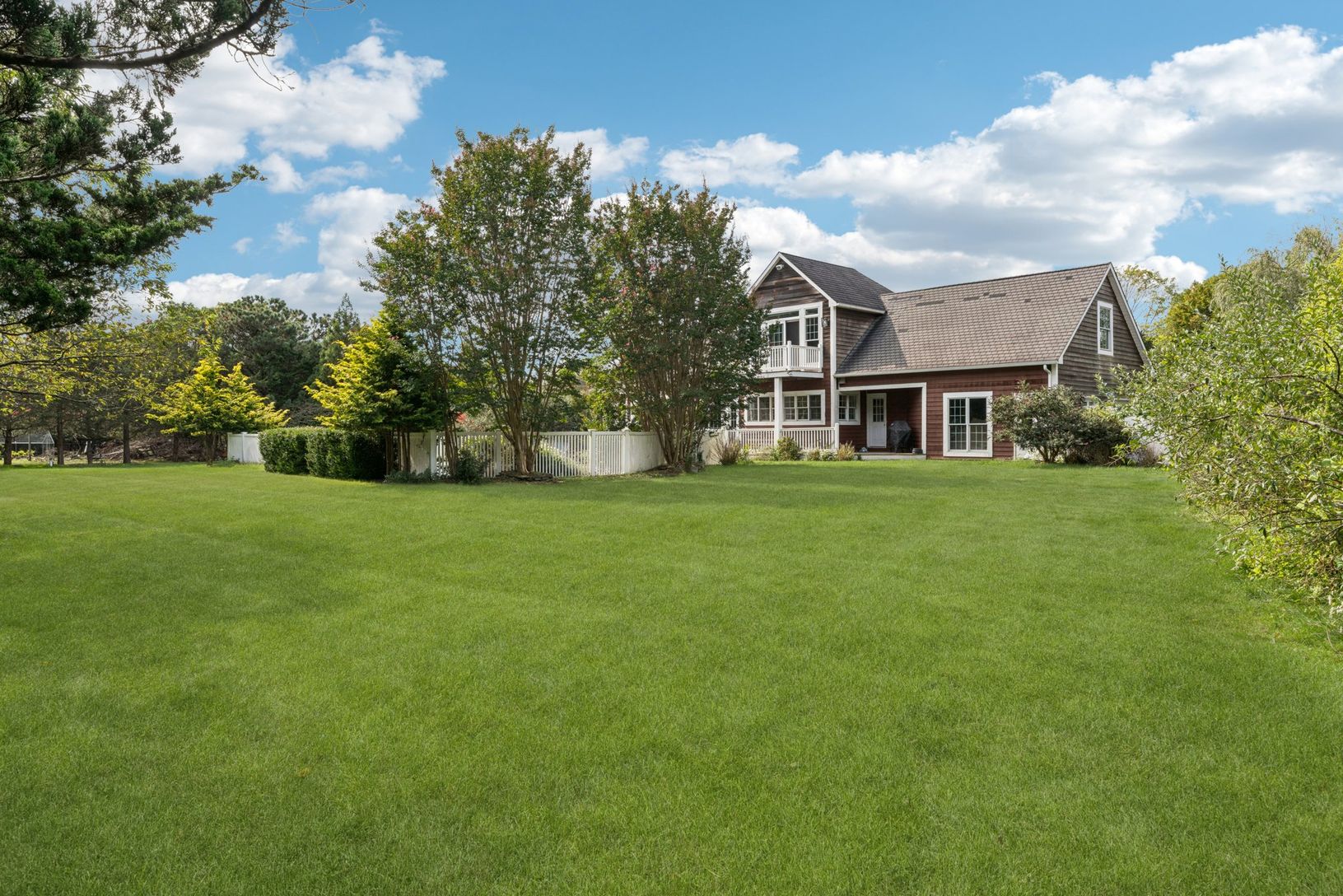 The rear elevation of the home presents a harmonious blend of comfort and sophistication.