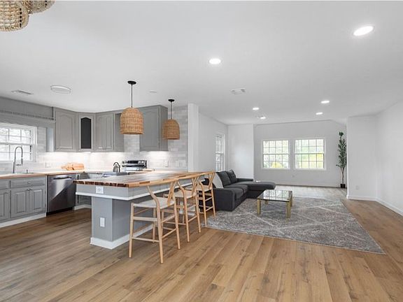 Main living area: home office, living room, kitchen, can''t see dining area from this view. Open floor plan.