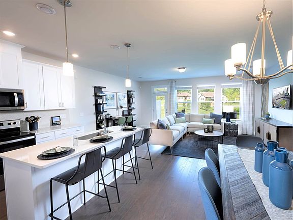 Large windows allow light to flood into the open-concept living space.