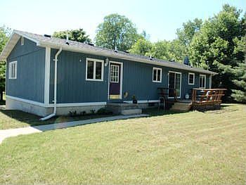 Back Entrance to the Home, there is a 12x10 wood deck off the eating area in the Kitchen.
