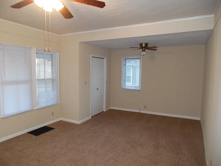 Living Room is 20' x 13'. Double windows face front of the house, coat closet, small window faces east
