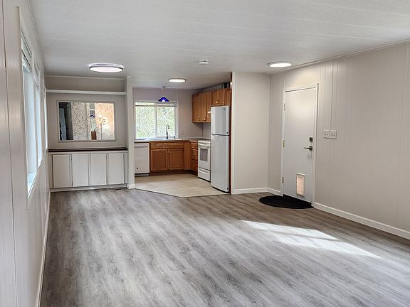 Another View of Living Room, with Kitchen and Laundry beyond. Front Door is to Right.