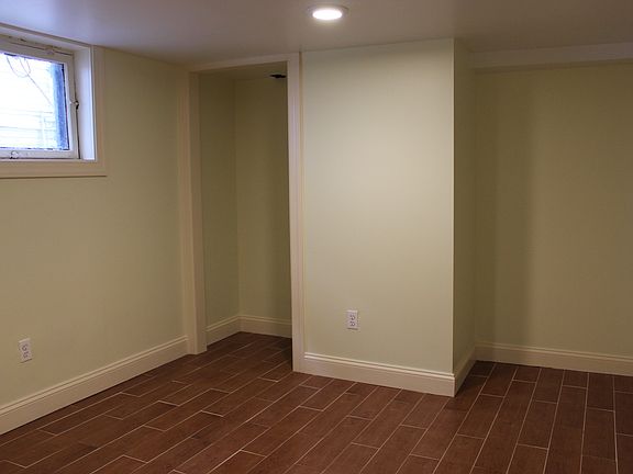 Bedroom with lots of natural light, dual closets and wood look tile flooring for easy cleaning.