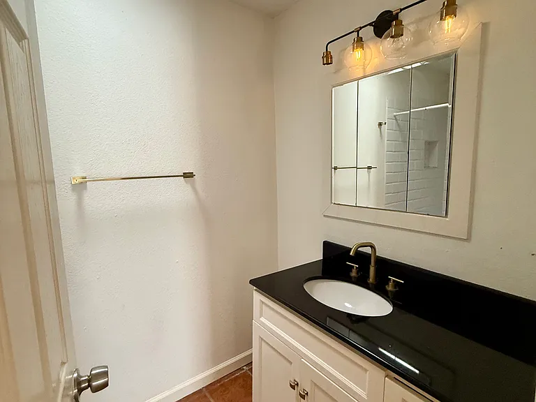 Bathroom in 2nd BR Flex Suite. Skylight overhead and shower and toilet nook on L, visible in next pictures.
Note: vanity light over medicine cabinet and sink being replaced.