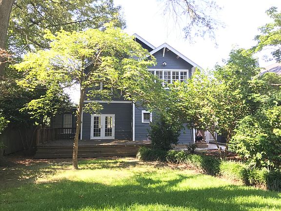 private fenced backyard with large deck and storage shed