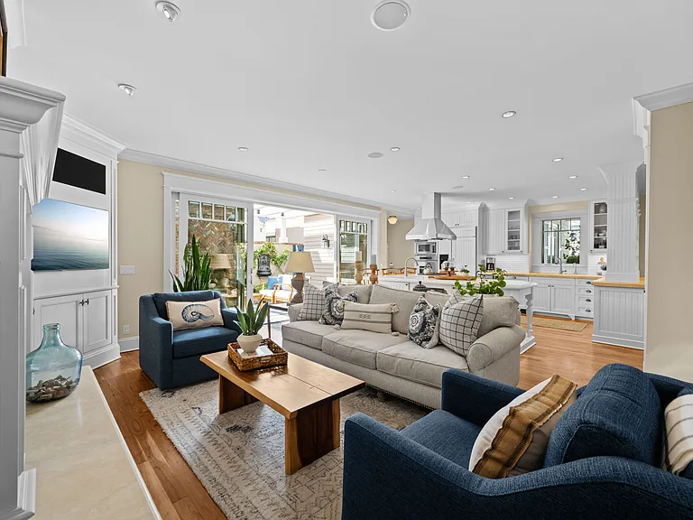 Beautiful open floor plan with large slider doors to backyard, custom built-ins and crown molding throughout