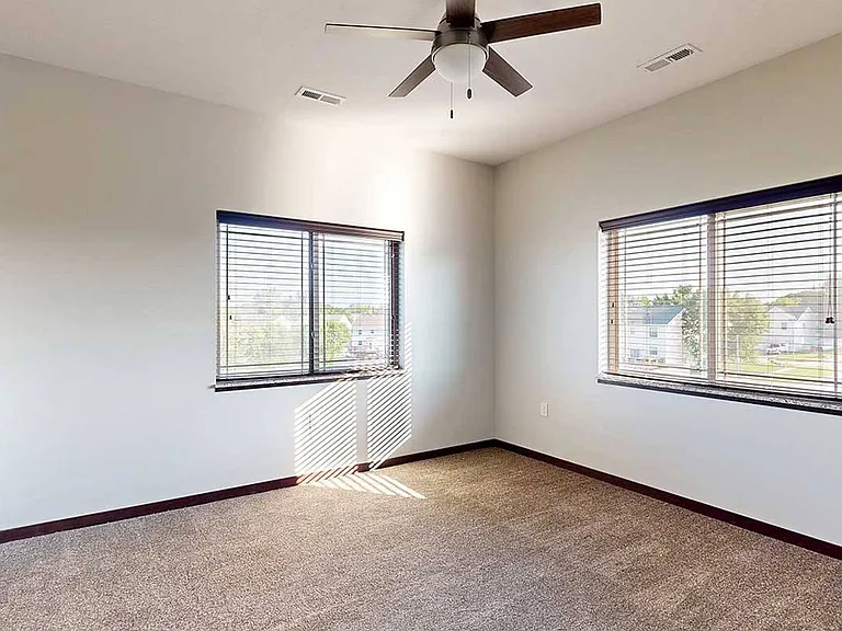 Enjoy a spacious bedroom with large windows that let in plenty of natural light.
