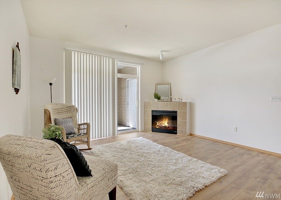 Gorgeous New Flooring, High Ceilings, Fresh Paint, Large Balcony w/Storage & a Corner Fireplace!